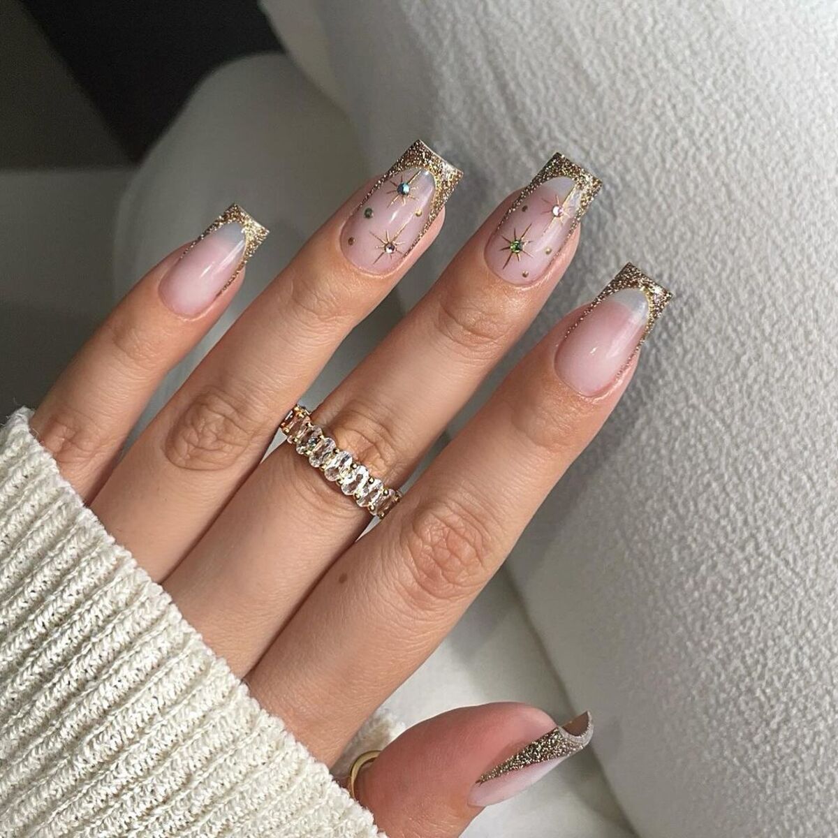 10. Golden Glitter French Tips with Star Accents