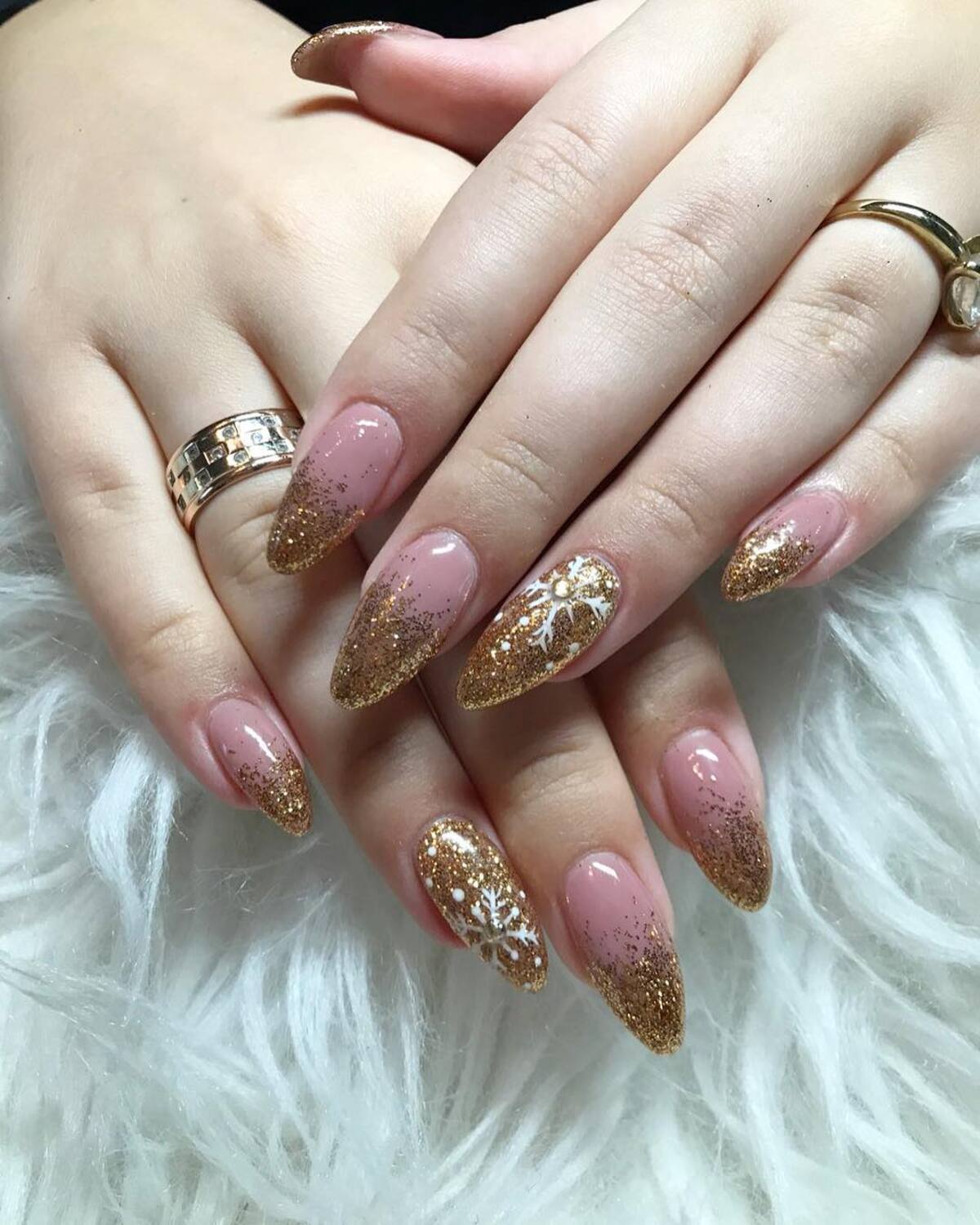 17. Glittery Gold French Tips with Snowflake Details