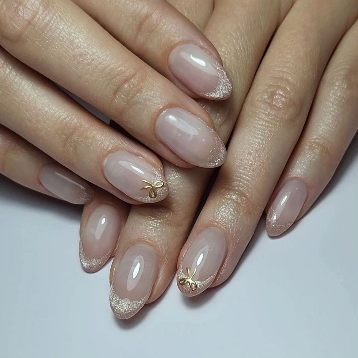 3. Subtle Glitter French Tips with Gold Accents