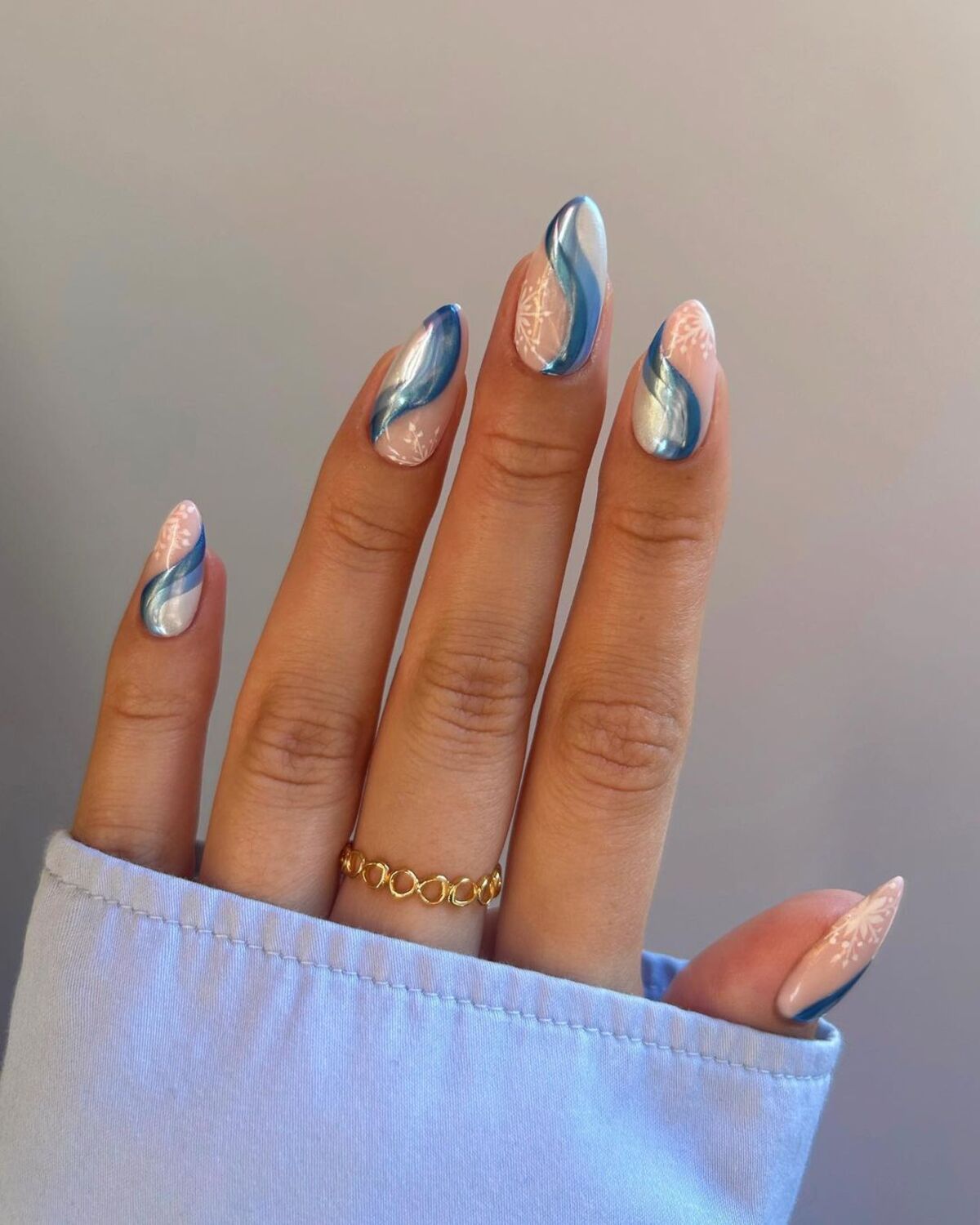 11. Shimmering Blue Swirls on Almond Nails