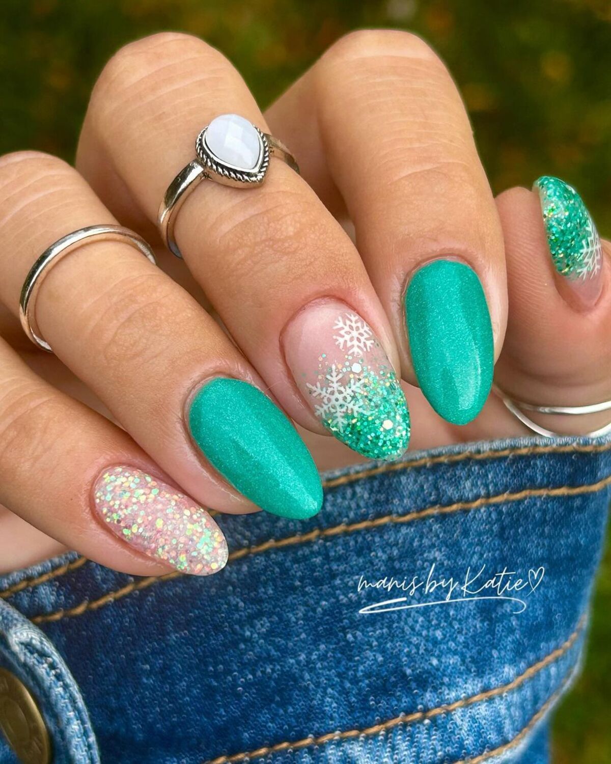 15. Vibrant Teal and Snowflake Nail Art