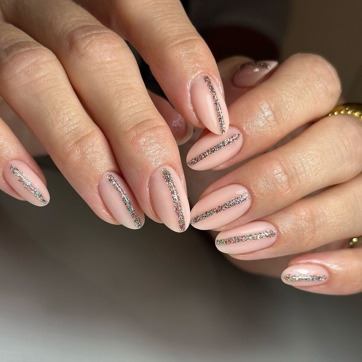 3. Glittery Linear Accents on Almond Nails