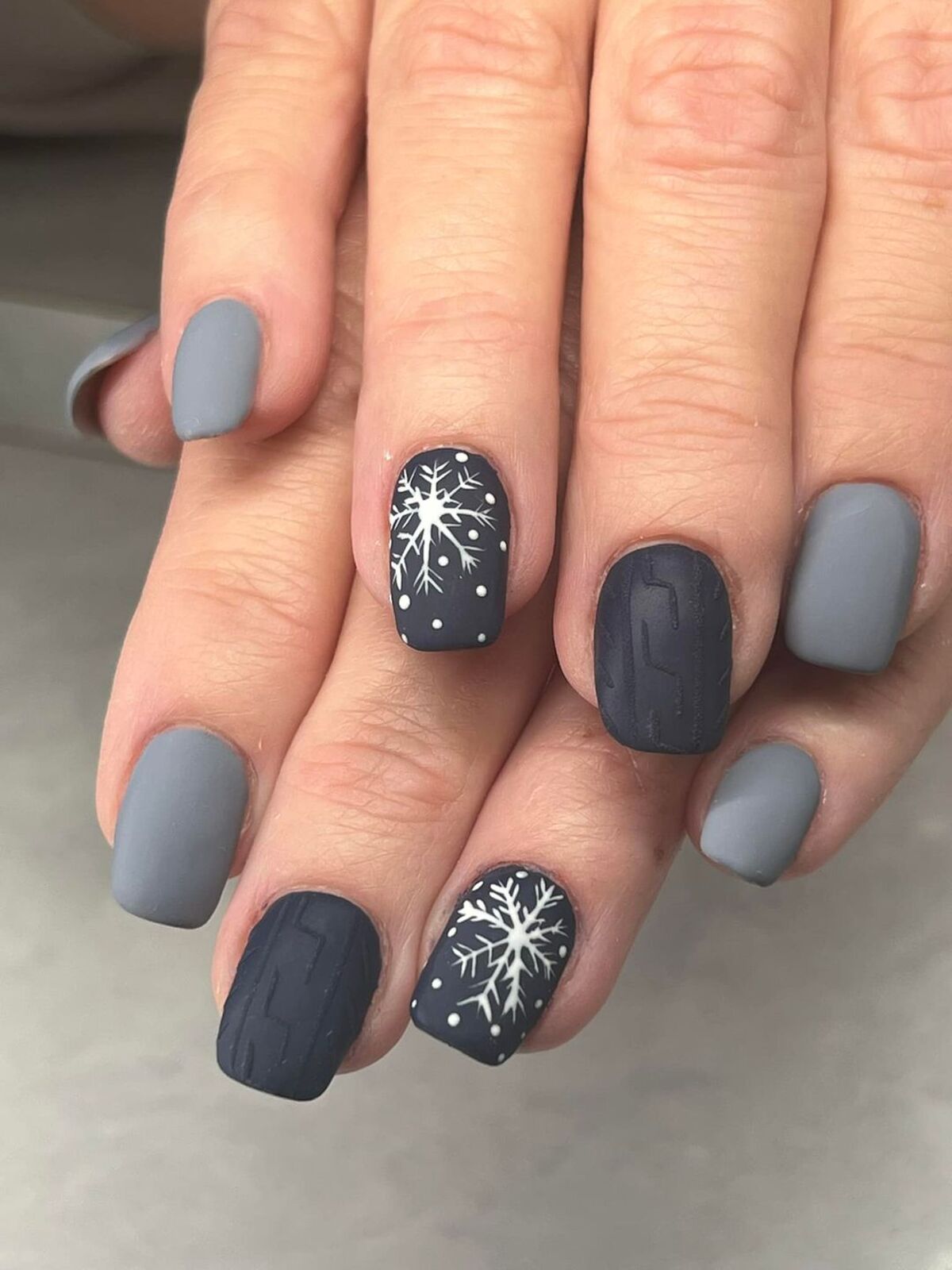 6. Sleek Navy and Gray Snowflake Nails