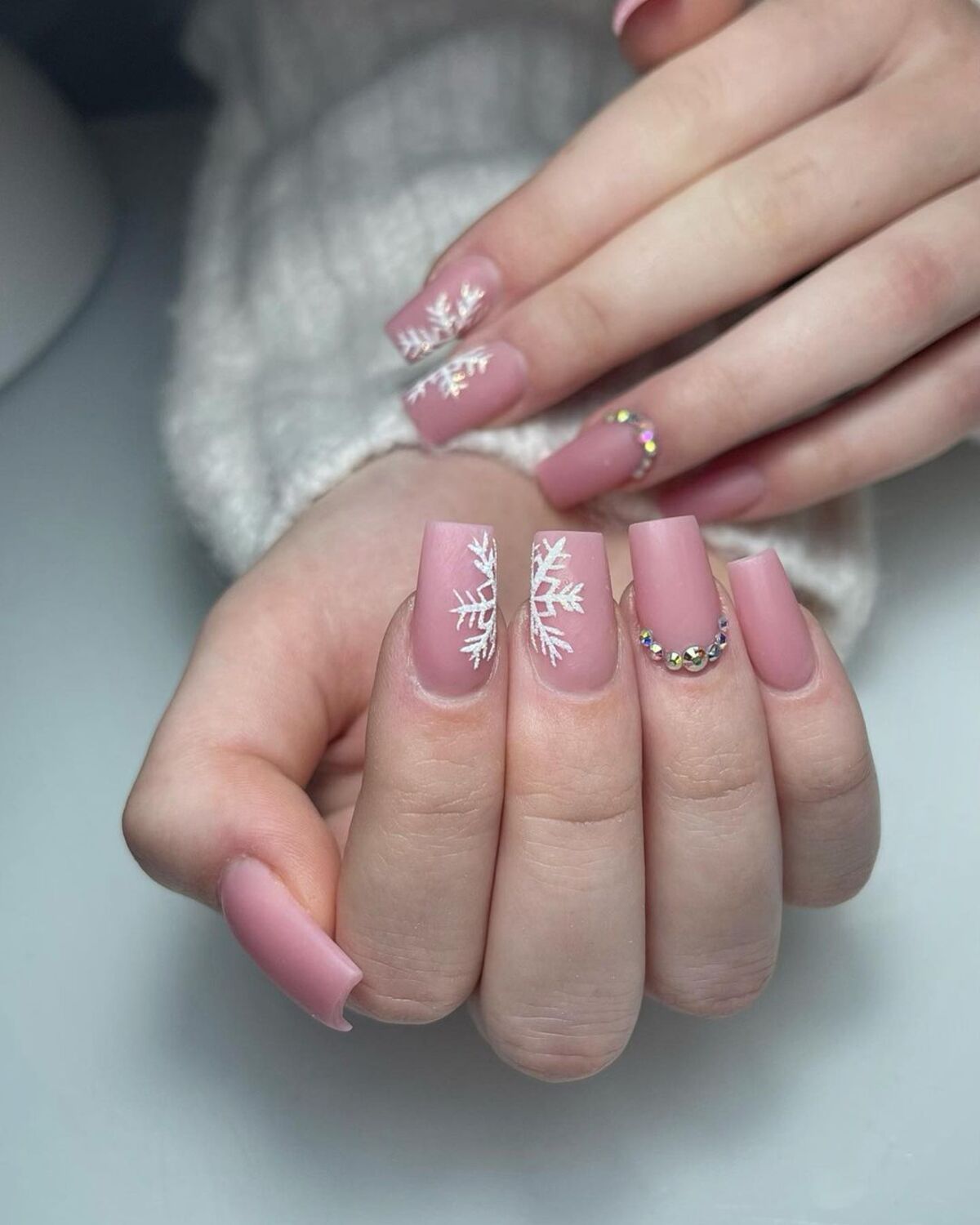 7. Blush Pink Nails with Snowflake Elegance