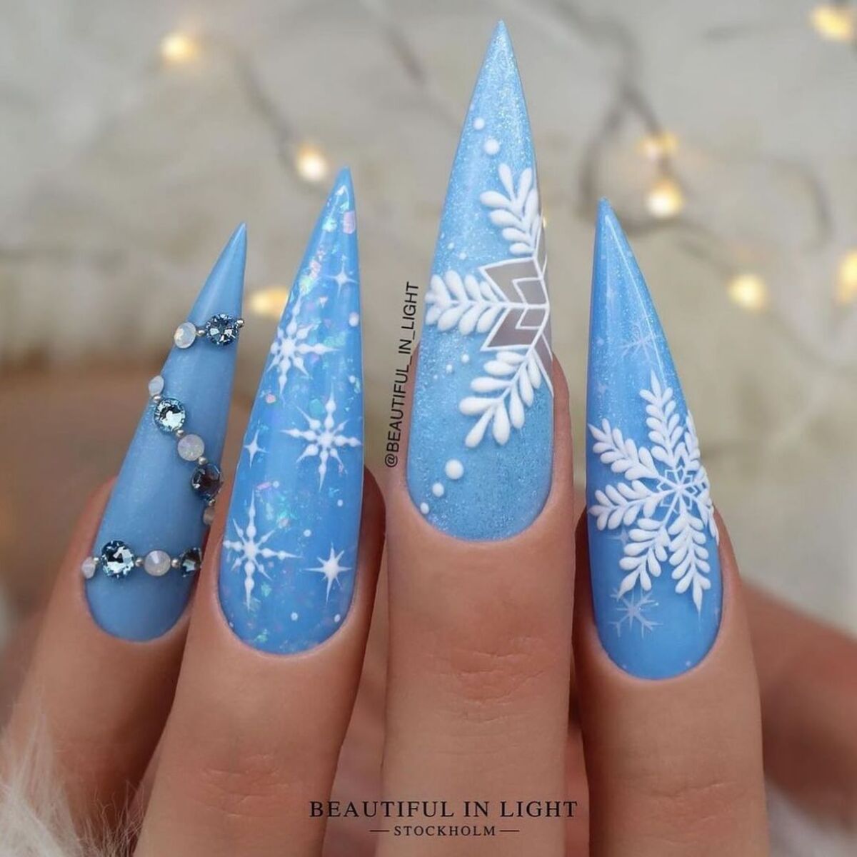 3. Bold Blue Stiletto Snowflake Nails