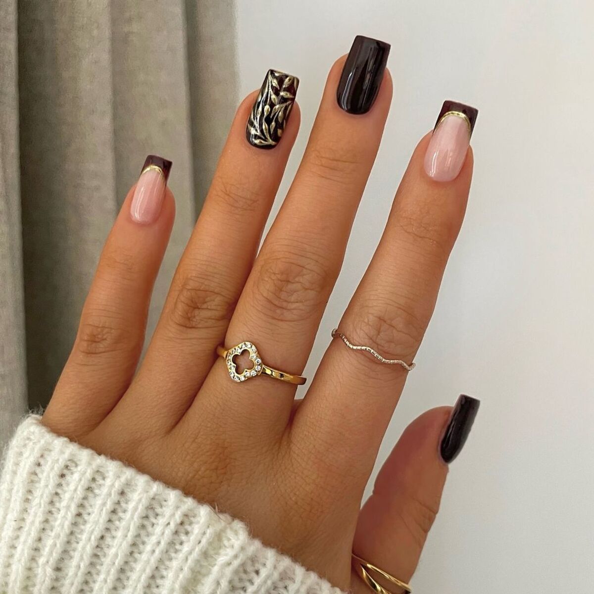 7. Elegant Black and Nude French Tips with Gold Accents