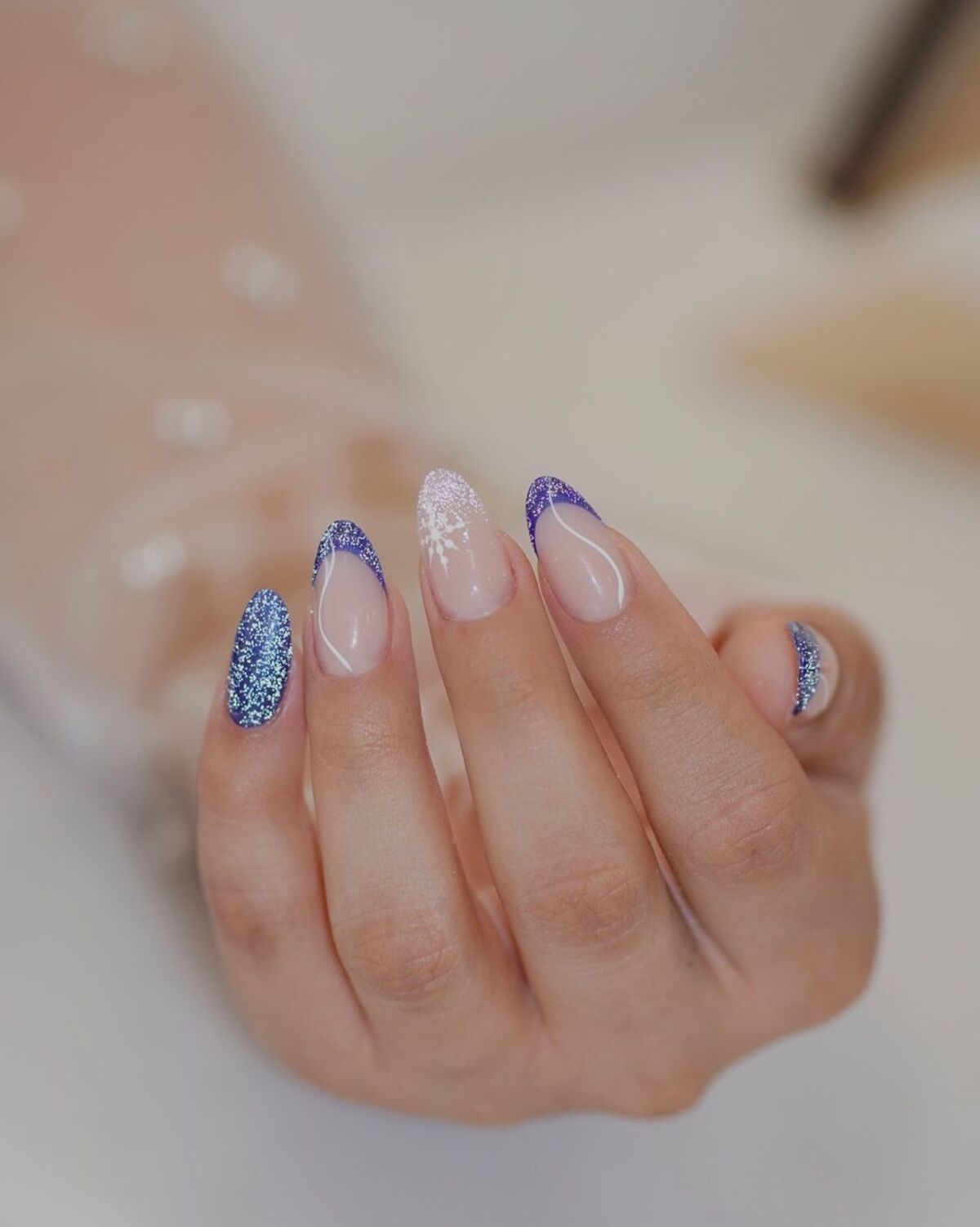 2. Elegant French Tips with Deep Blue Glitter