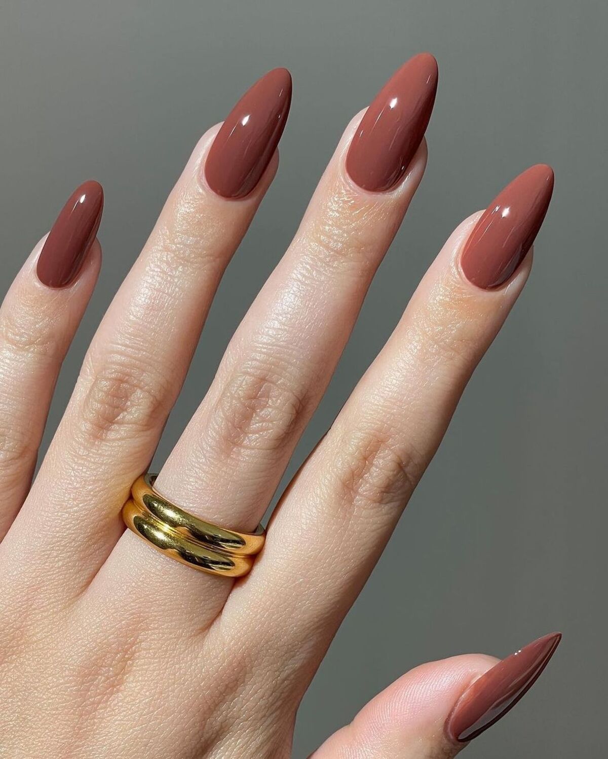 1. Minimal Elegance with Glossy Chestnut Almond Nails