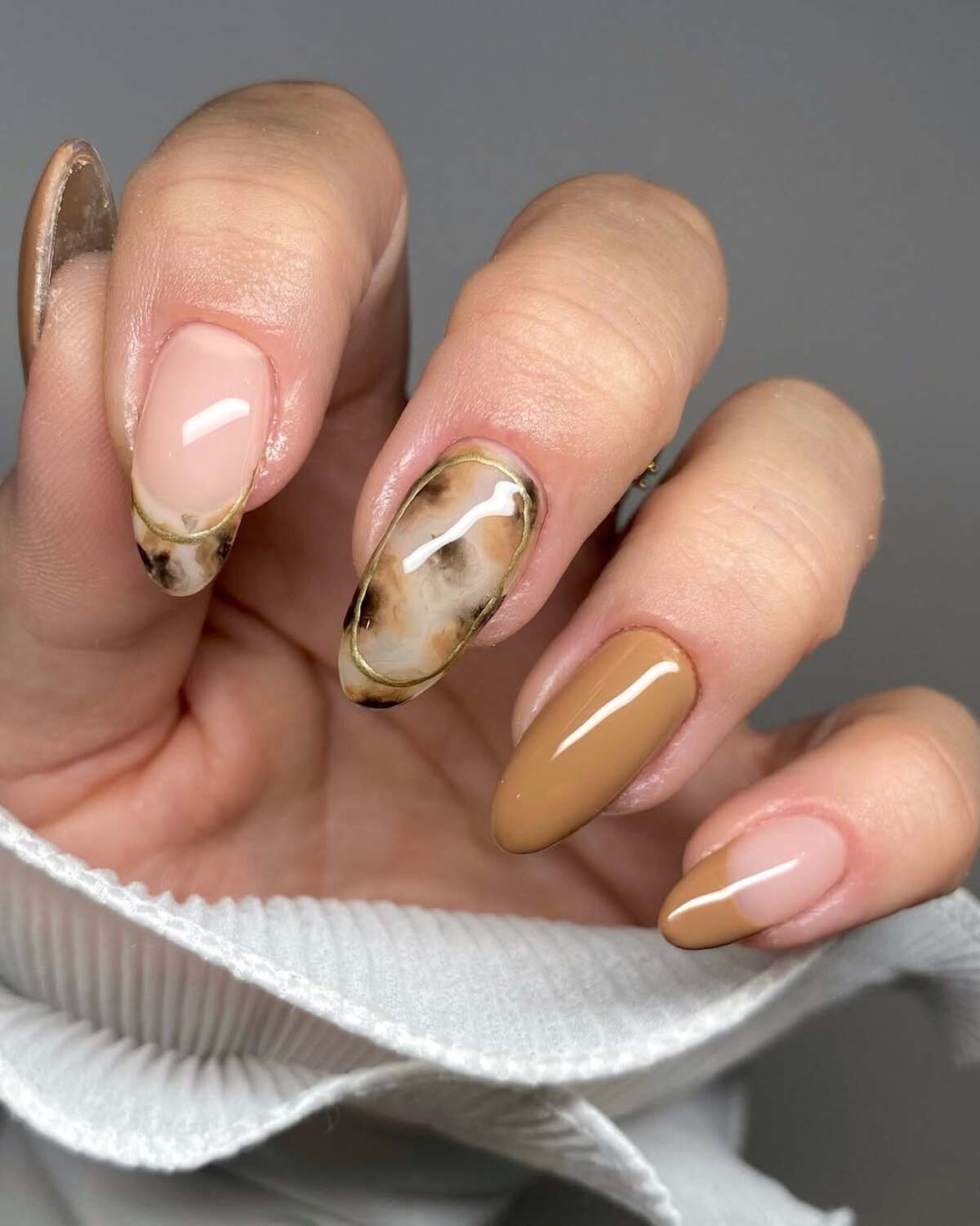 24. Marble Details on Warm Neutral Nails