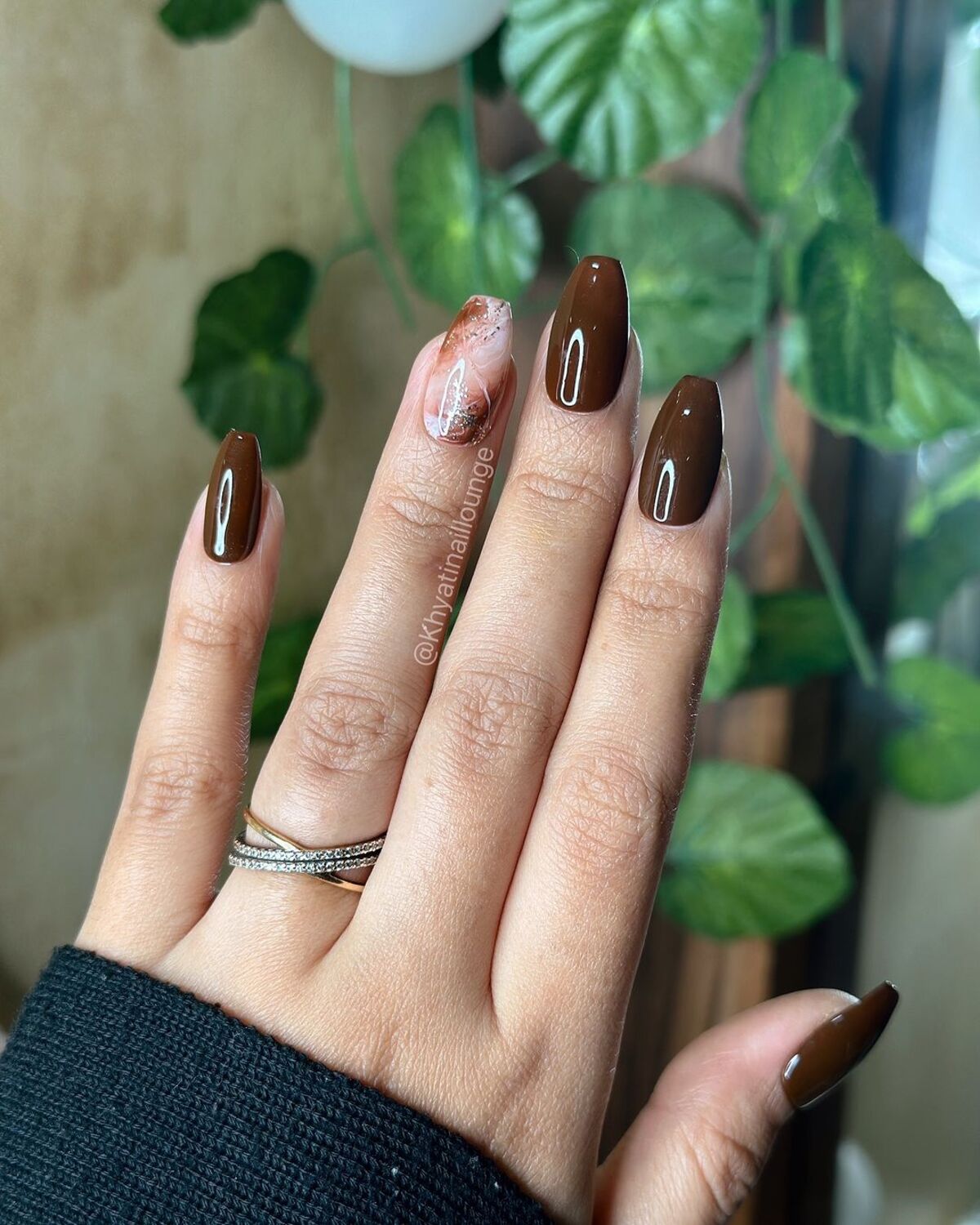 9. Chocolate-Tinted Nail Art with Marble Accents