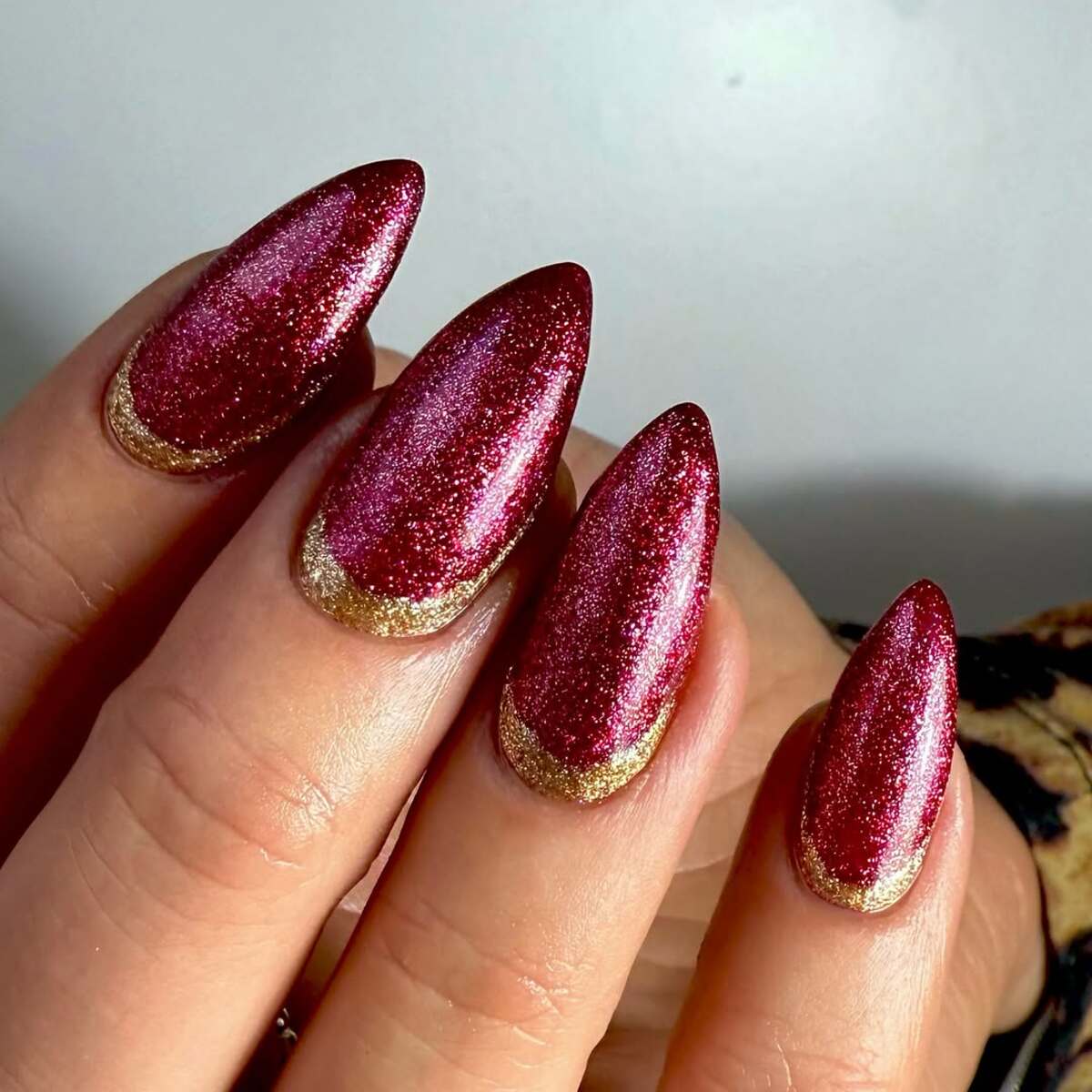 11. Metallic Red Nails with Gold French Tips