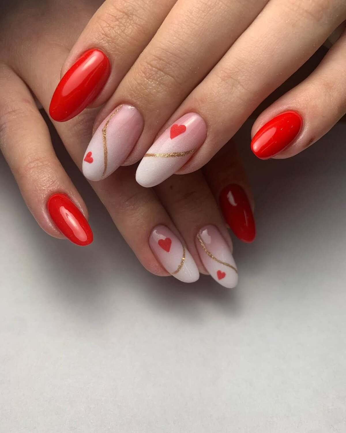 13. Minimalist Red and Heart-Filled Nude Nails