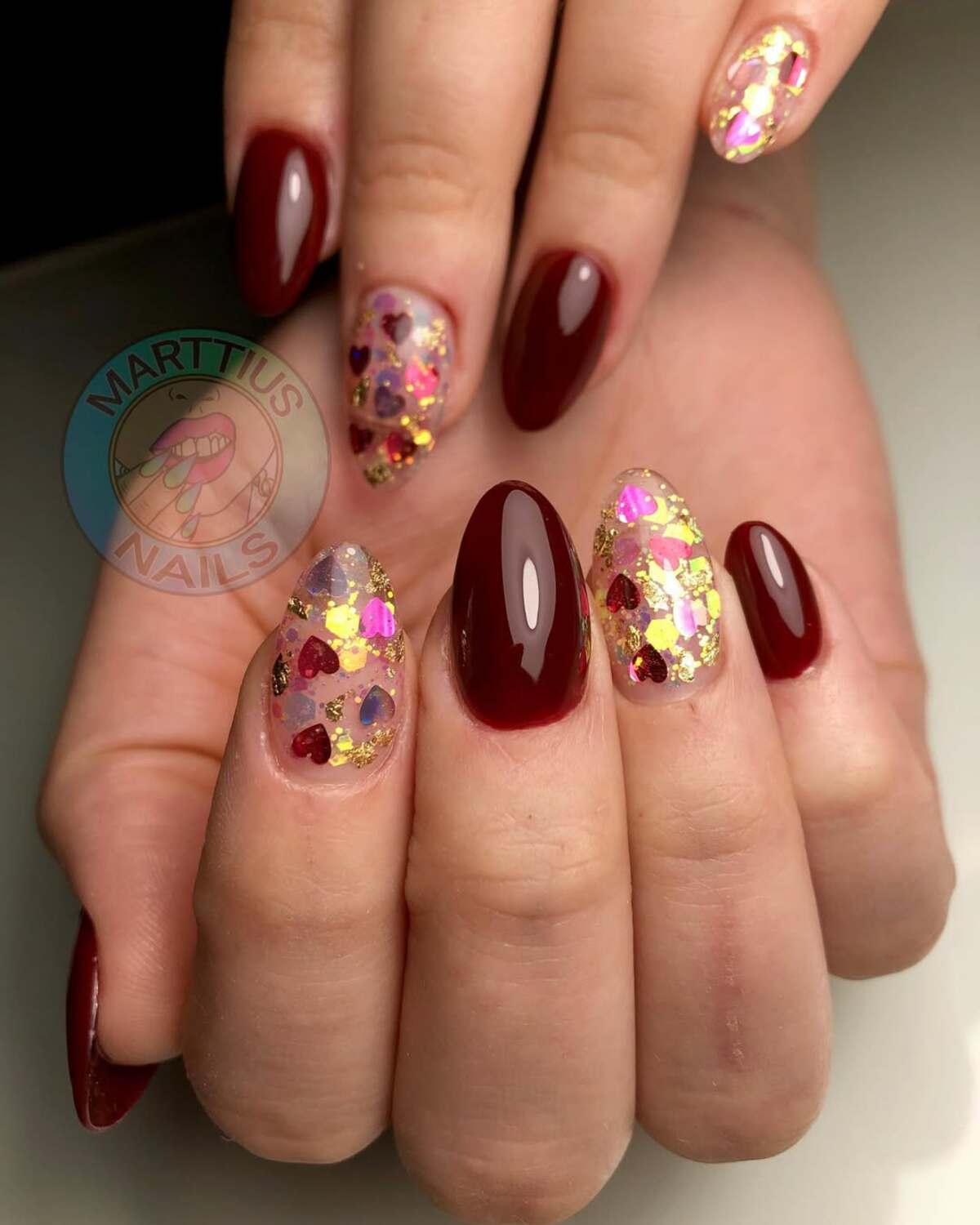 21. Glittering Heart Confetti on Crimson Nails