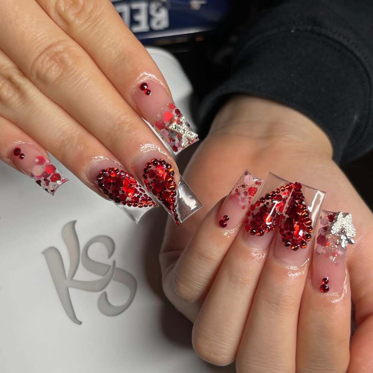 9. Red Gem-Filled Hearts on Clear Nails