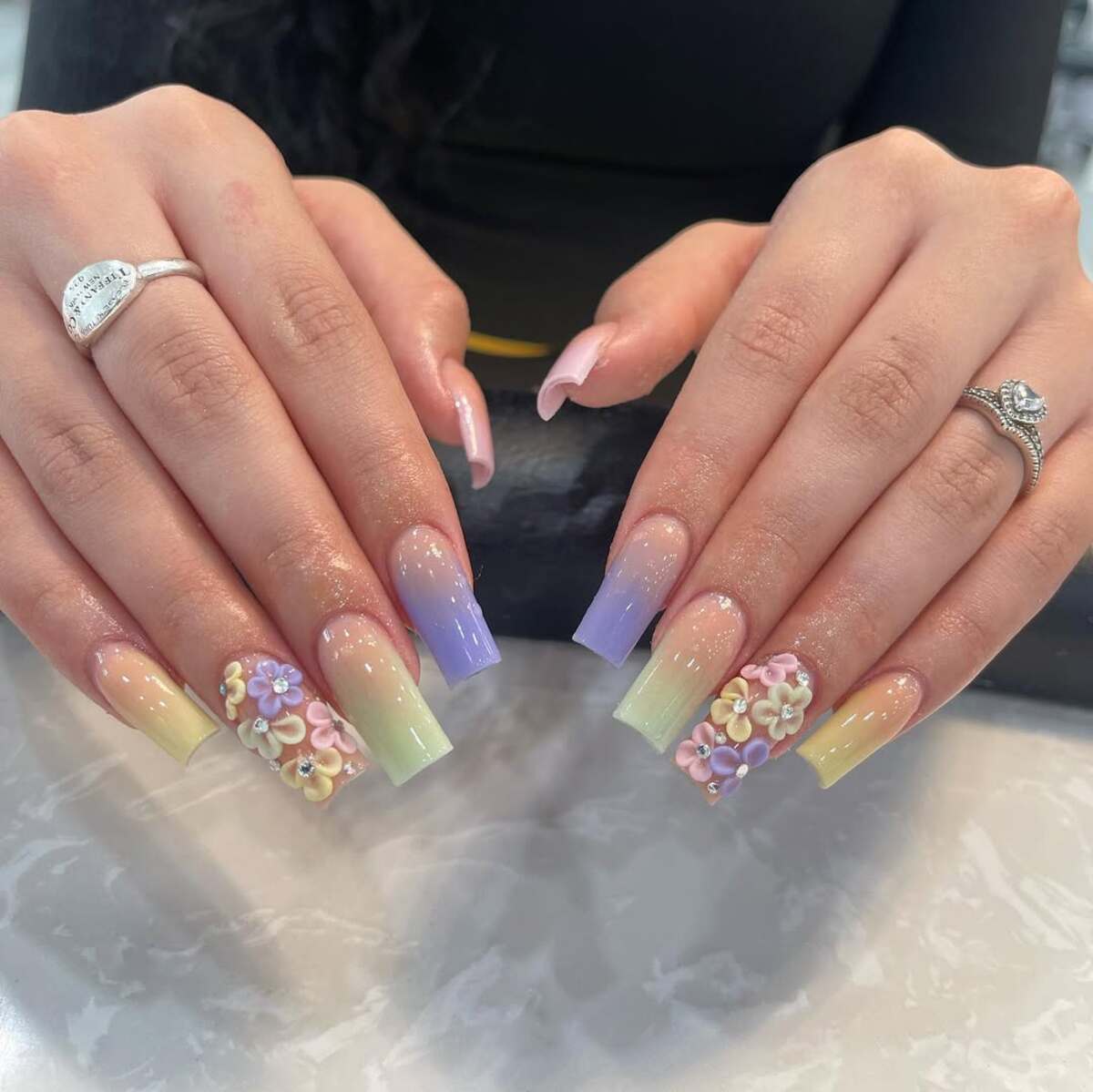 11. Pastel Rainbow French Tips with 3D Floral Embellishments