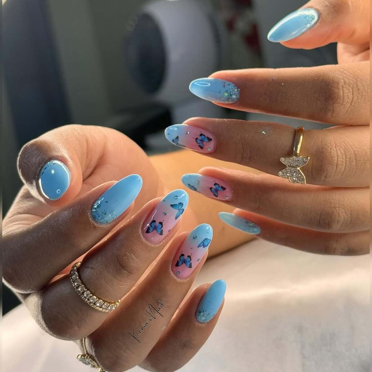 19. Sky Blue French Tips with Butterfly Accents