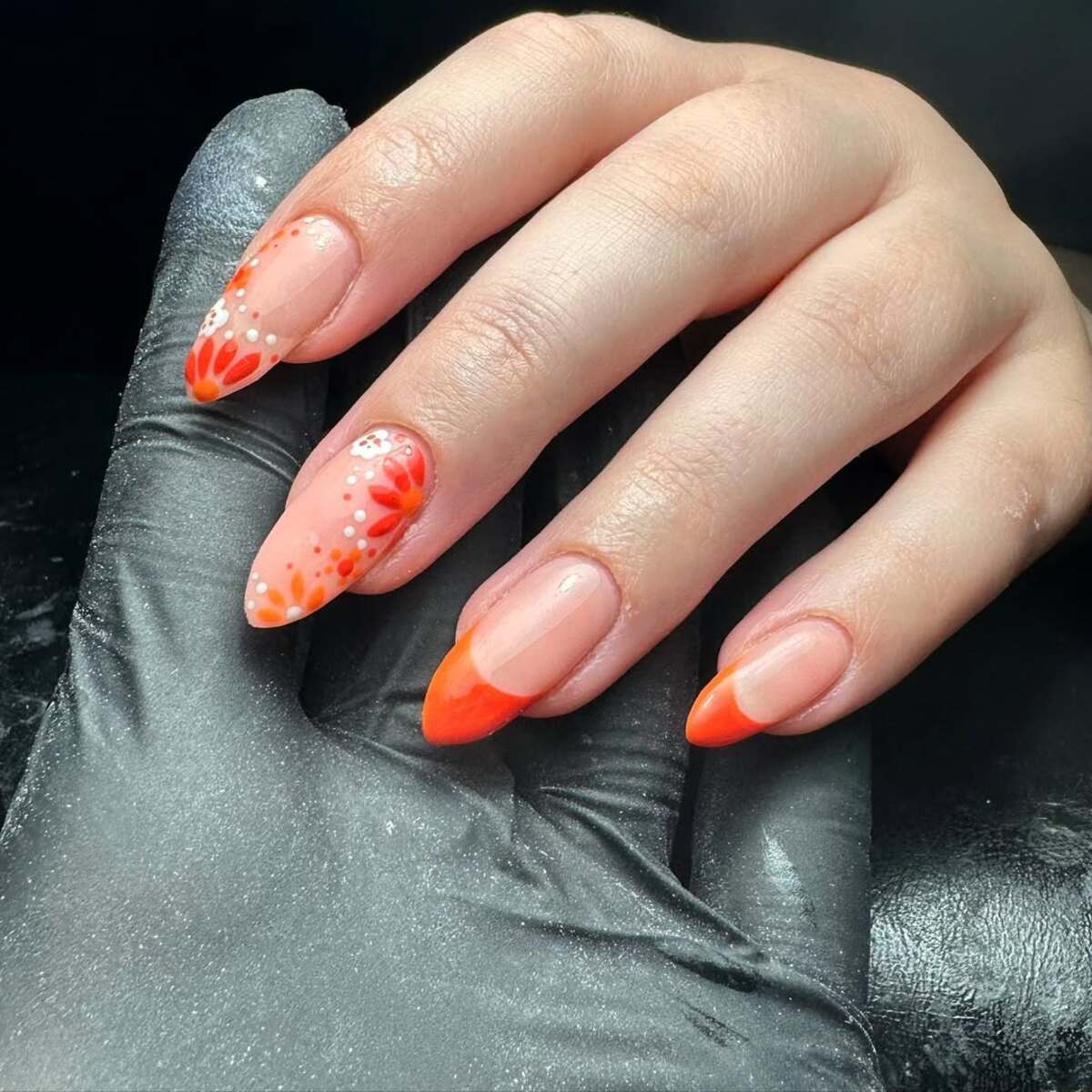 5. Vibrant Orange French Tips with Floral Patterns