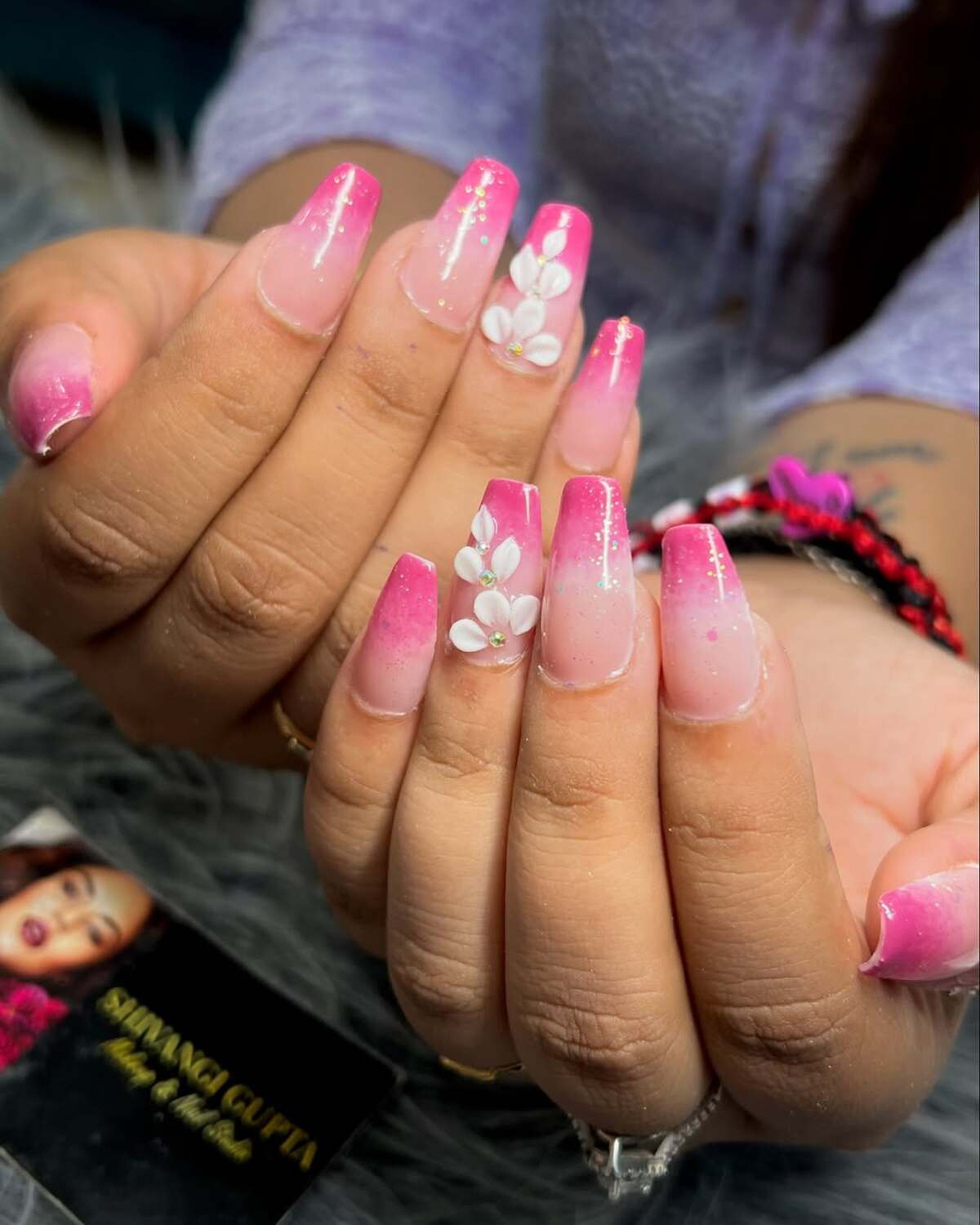 6. Ombre Pink French Tips with Subtle Glitter and Flowers