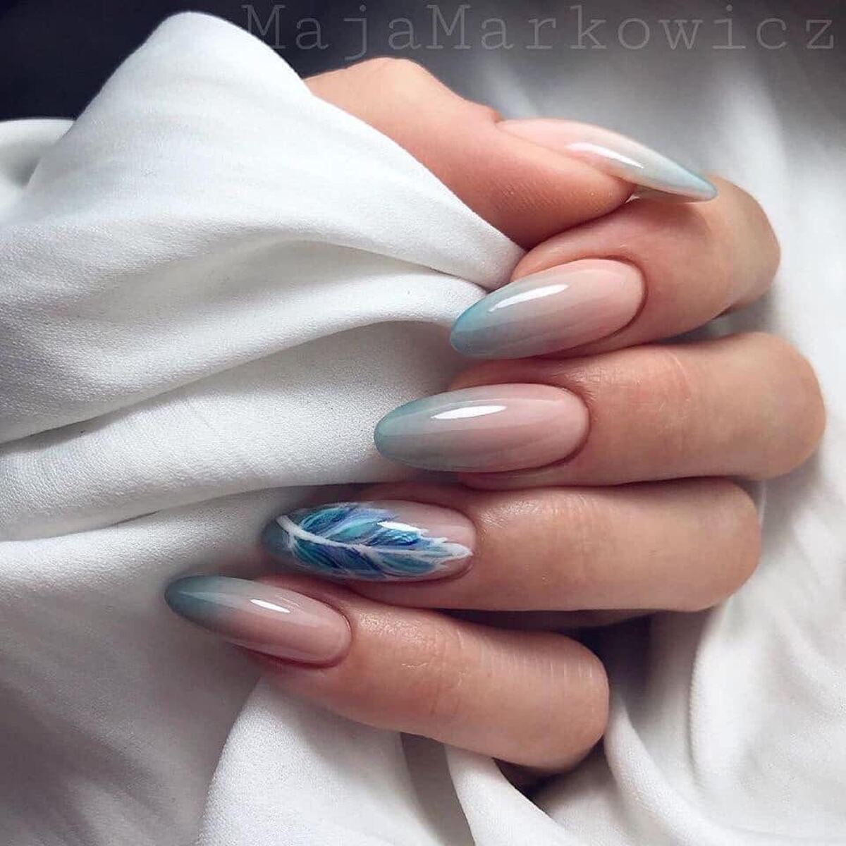 7. Soft Blue Gradient French Tips with Feather Accent