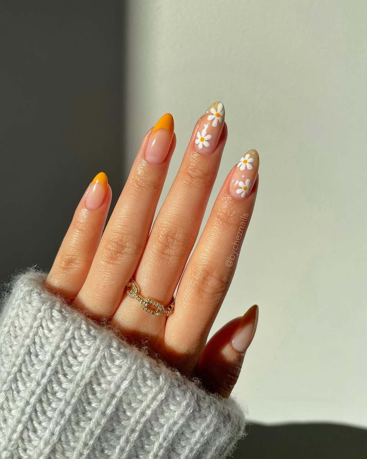 1. Bold Yellow Tips and Daisy Accents