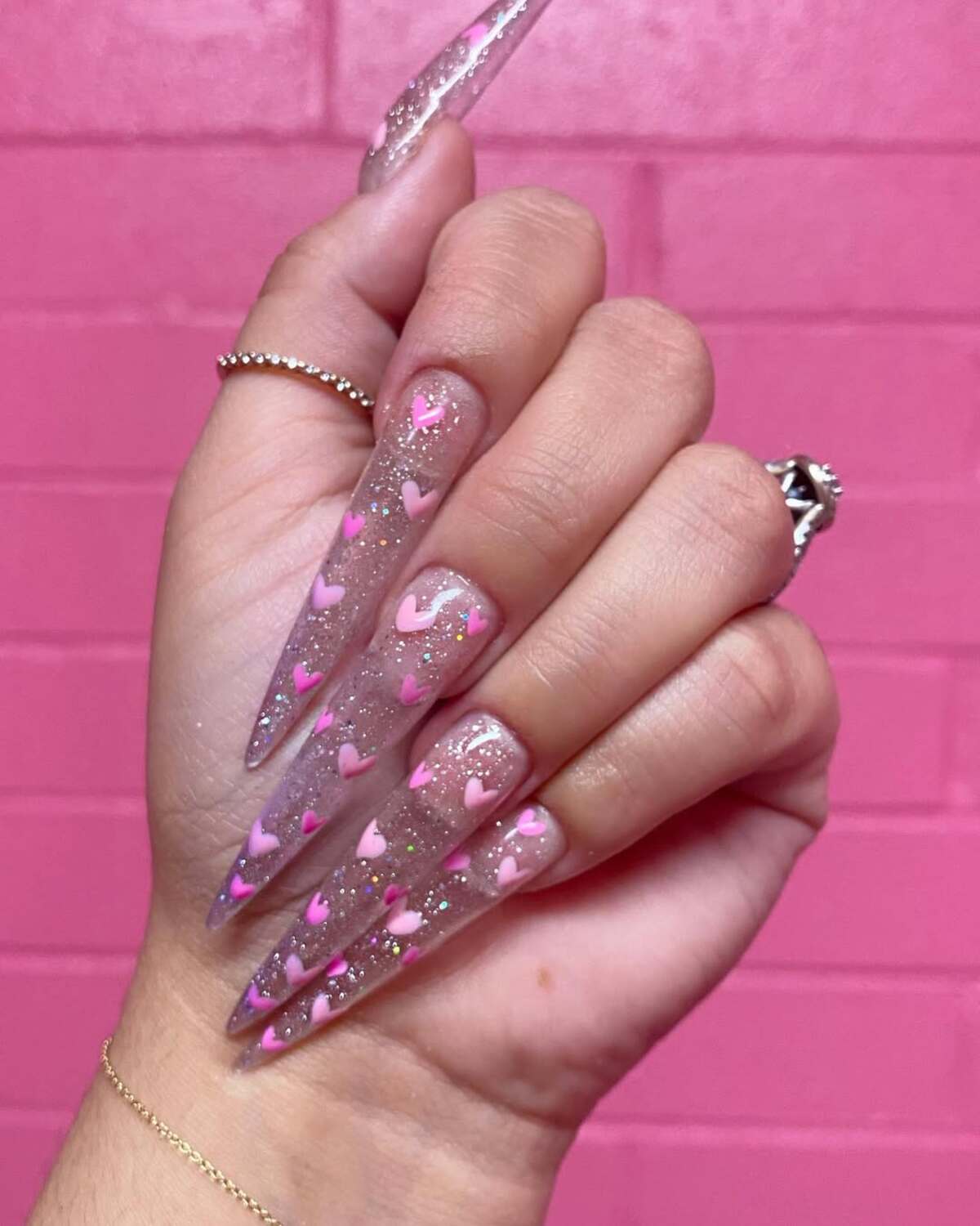 4. Stiletto Nails with Floating Pink Hearts