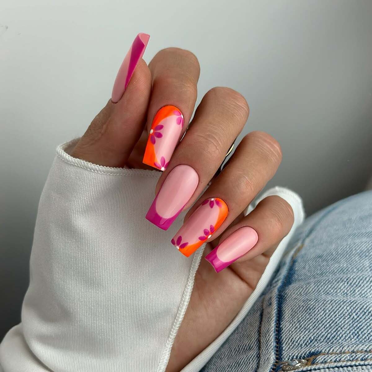 24. Bold Pink and Orange French Tips with Florals