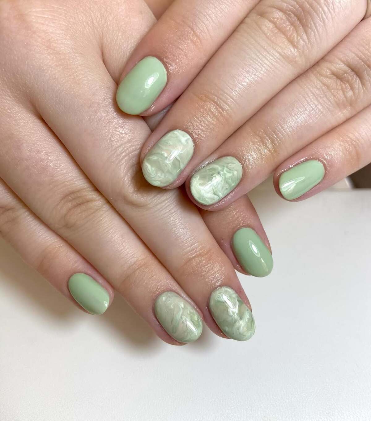 23. Marble Effect on Rounded Pastel Nails