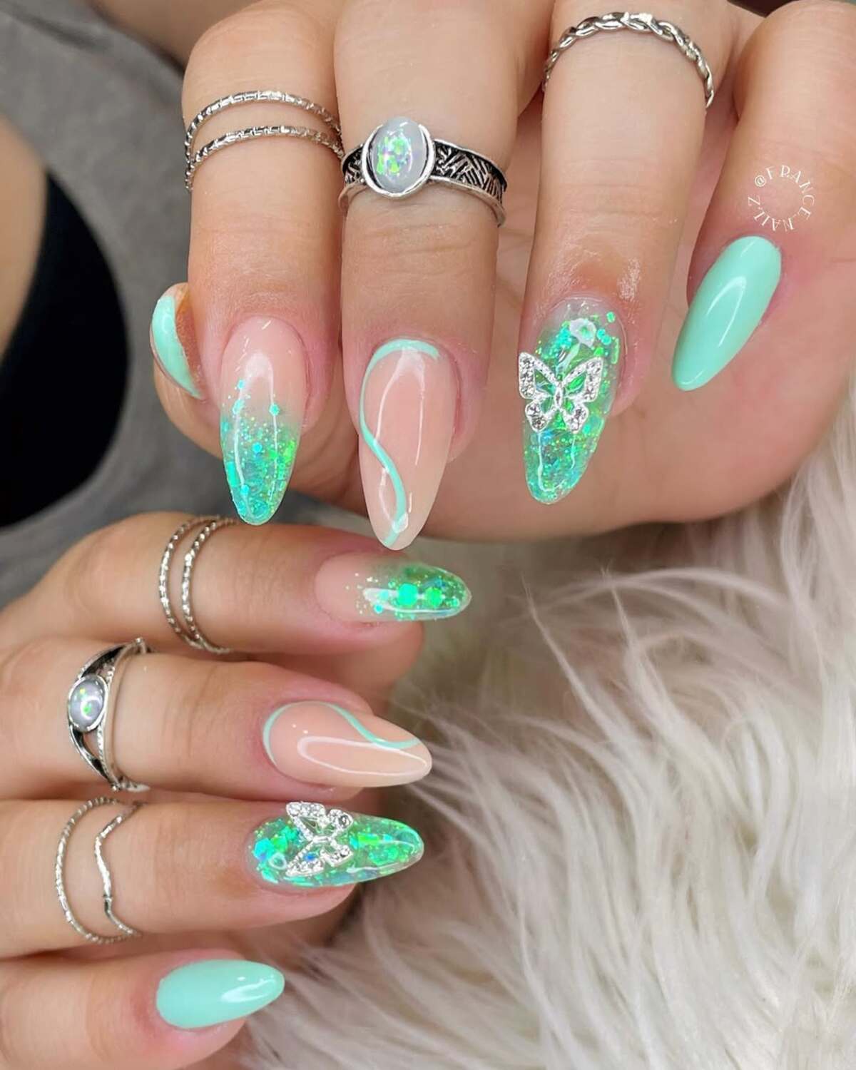 24. Glittering Butterfly Accents on Transparent Nails