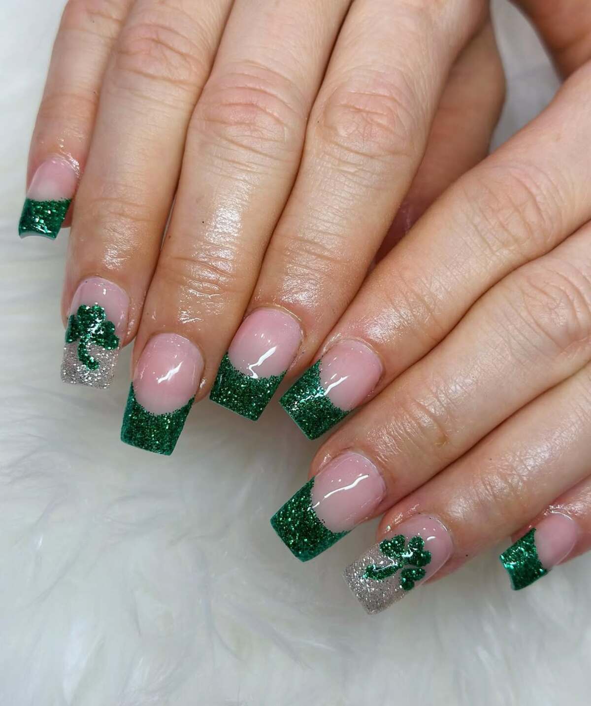 11. Glitter French Tips with Shamrock Accents