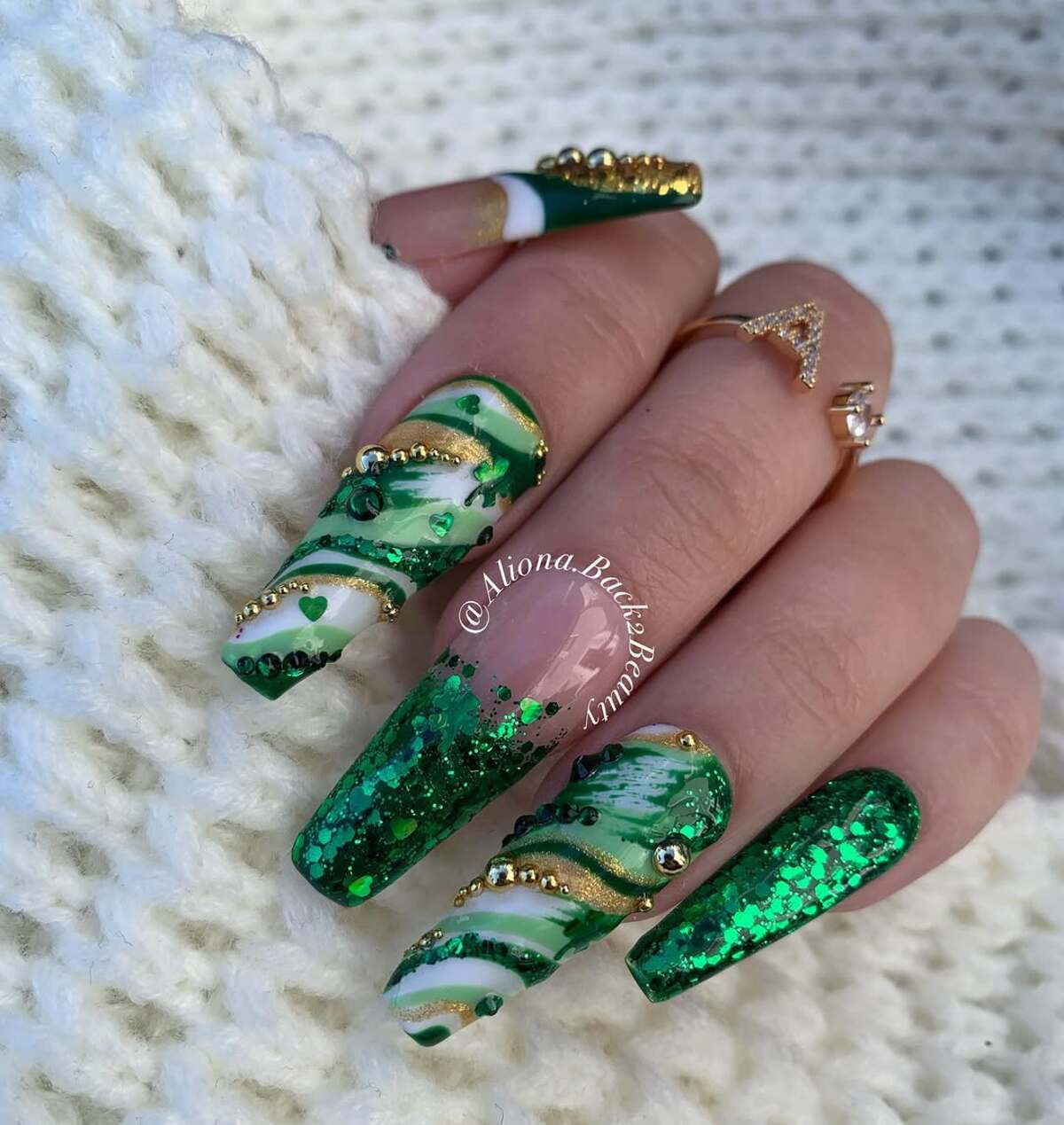 7. Luxe Green Marbled Nails with Gold Embellishments