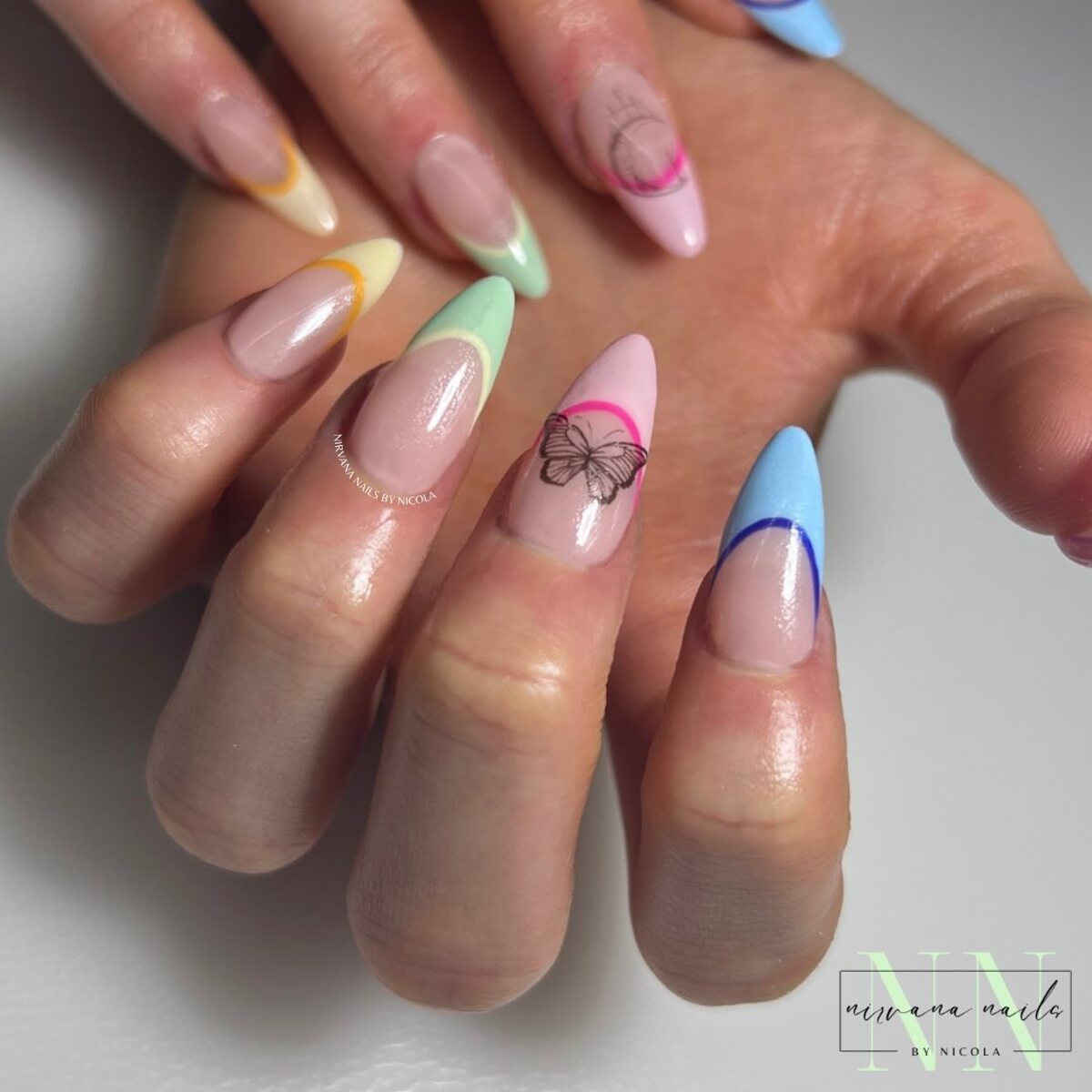 31. Pastel Rainbow Tips with Butterfly Accent