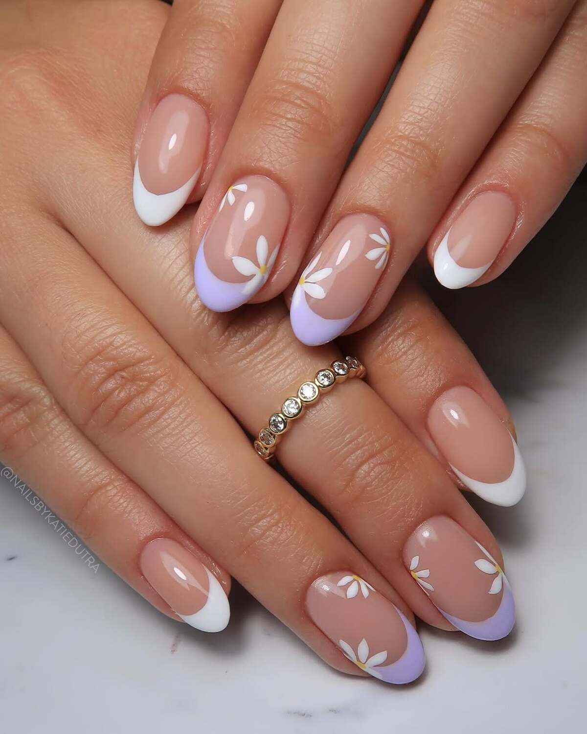 1. Classic French Tips with White and Lavender Daisy Accents