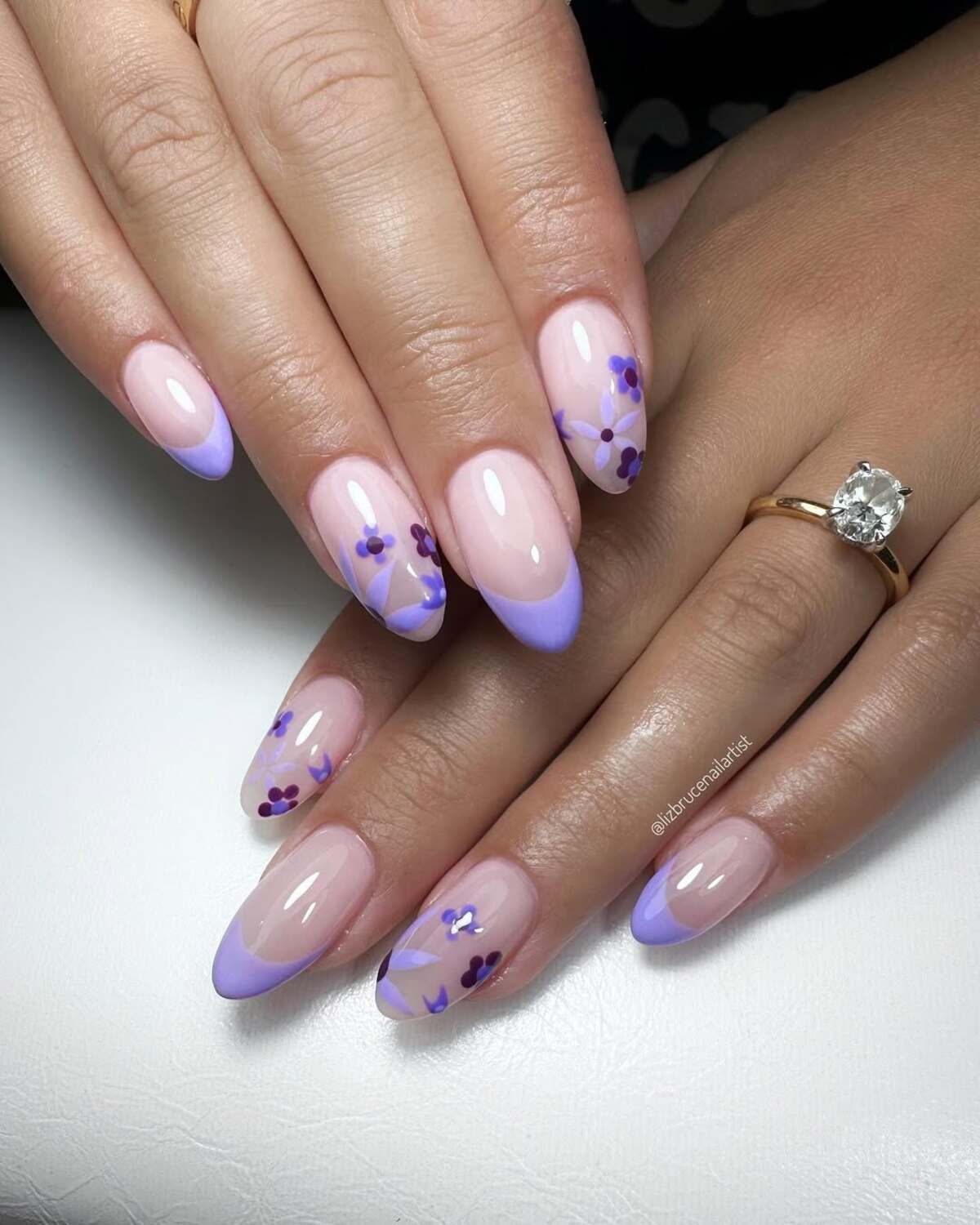 14. Pastel Purple French Tips with Artistic Flower Accents