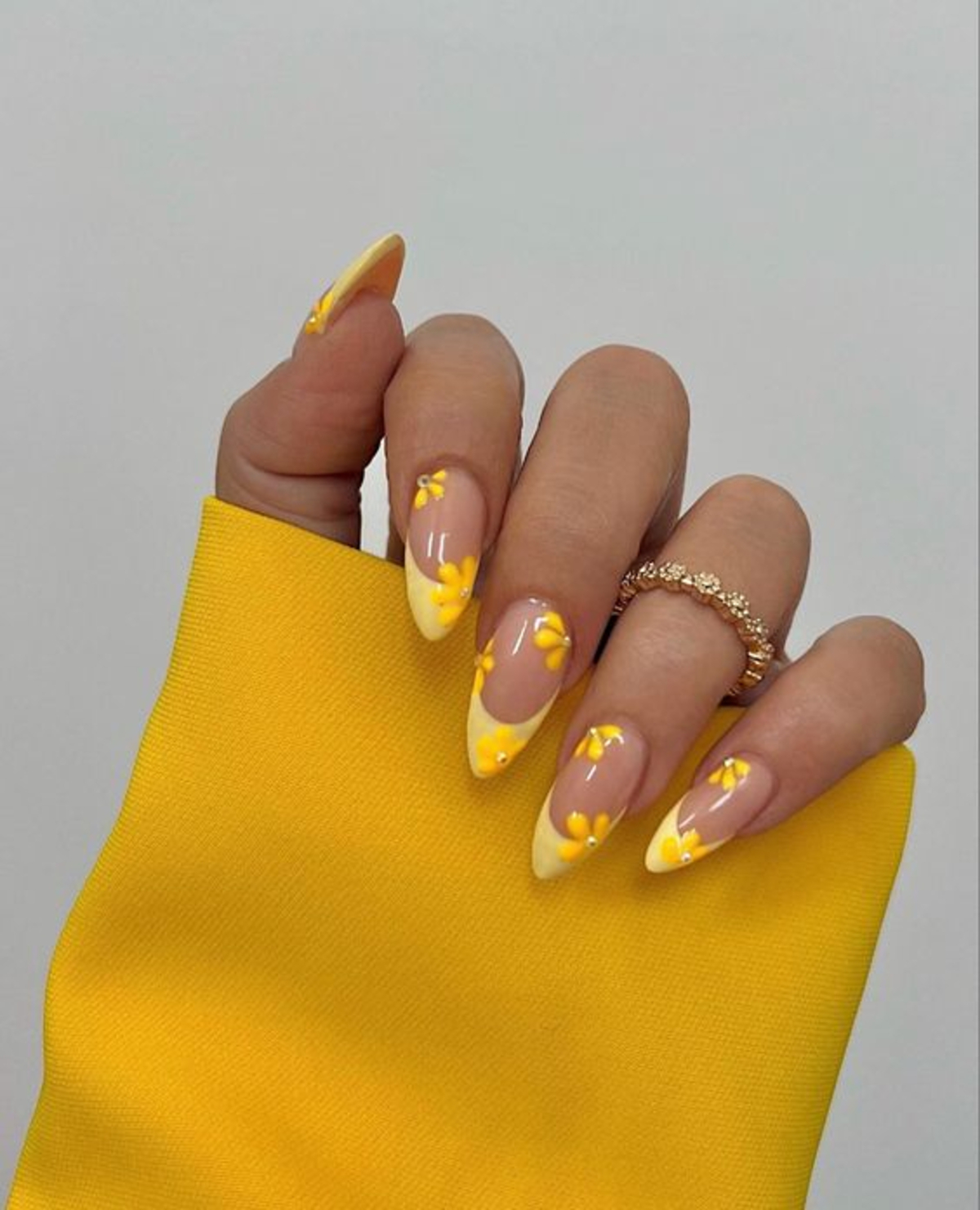 17. Soft Yellow French Tips with Matching Floral Accents