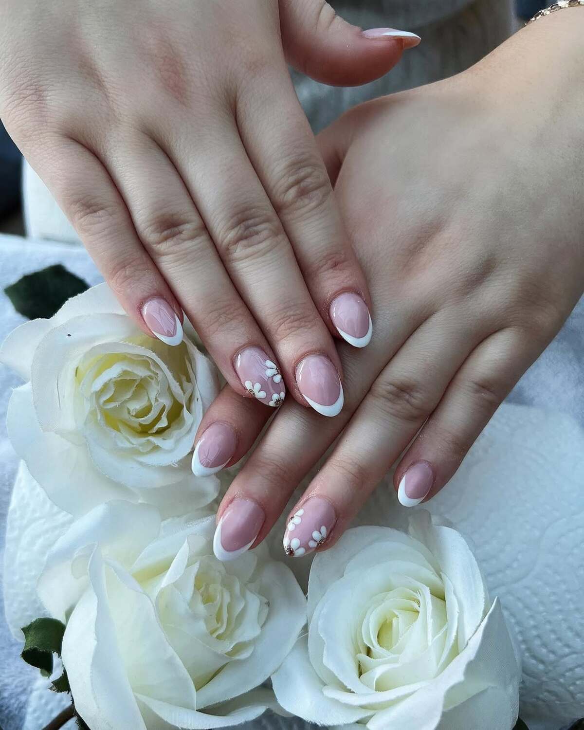 18. Classic French Tips with White Floral Accents