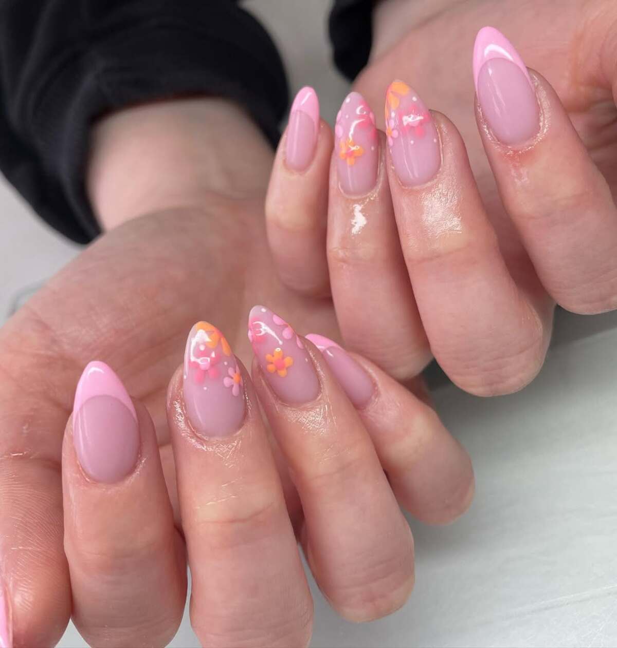 22. Pink French Tips with Colorful Floral Designs