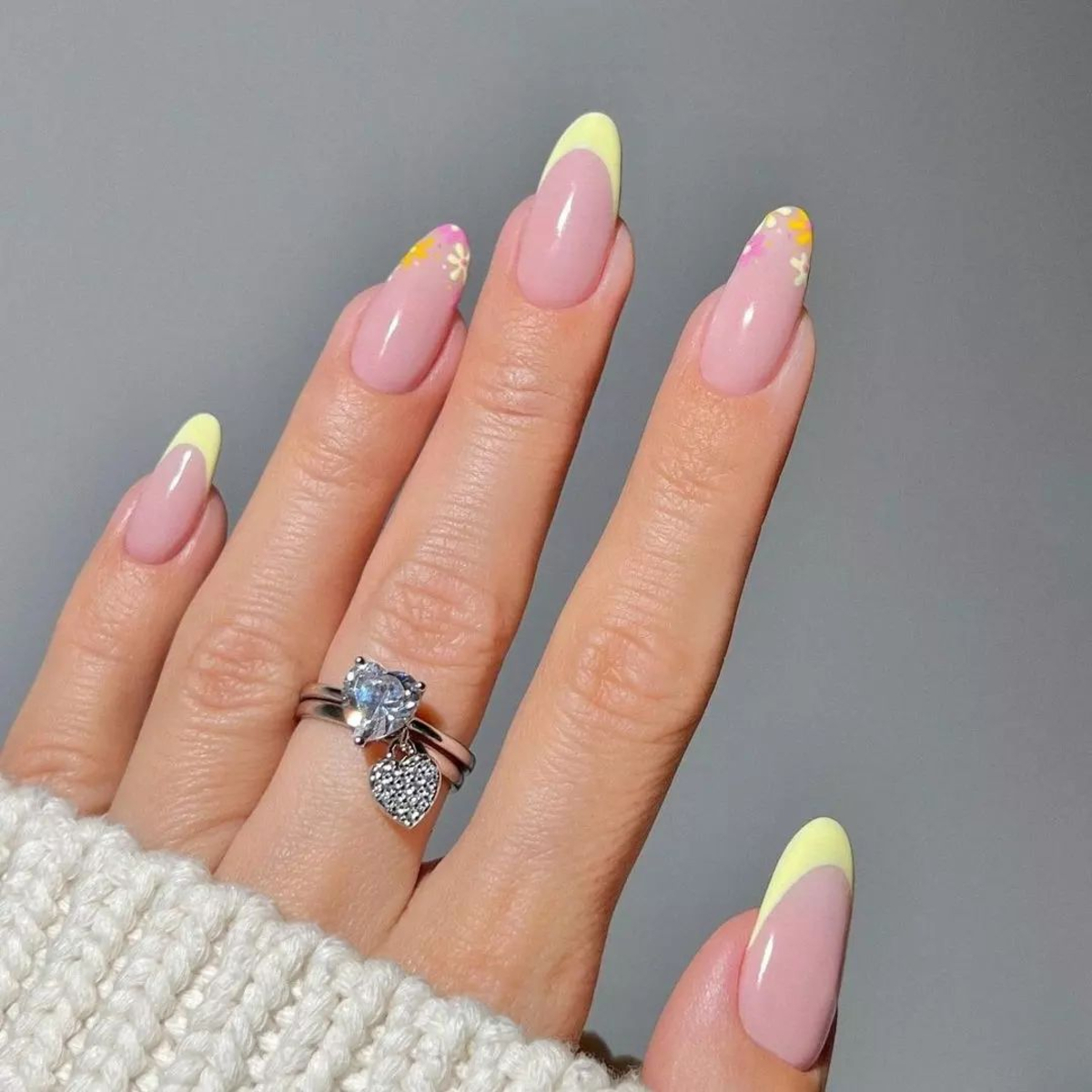 5. Soft Yellow Pastel French Tips with Subtle Floral Designs