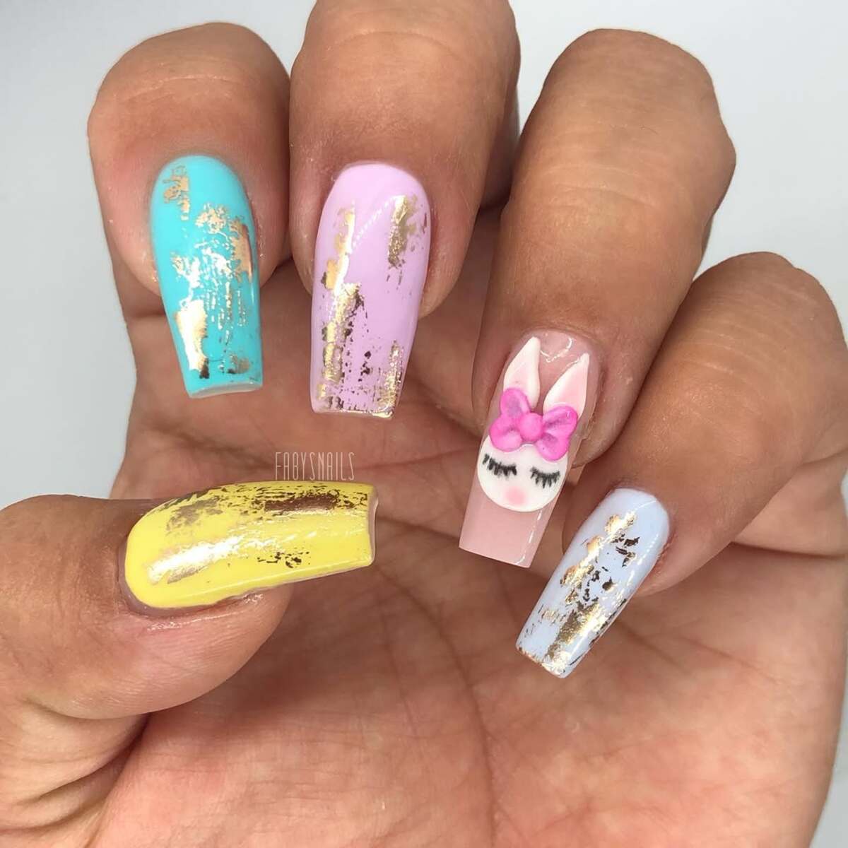 12. Luxe Pastel Nails with Gold Foil and Bunny Art