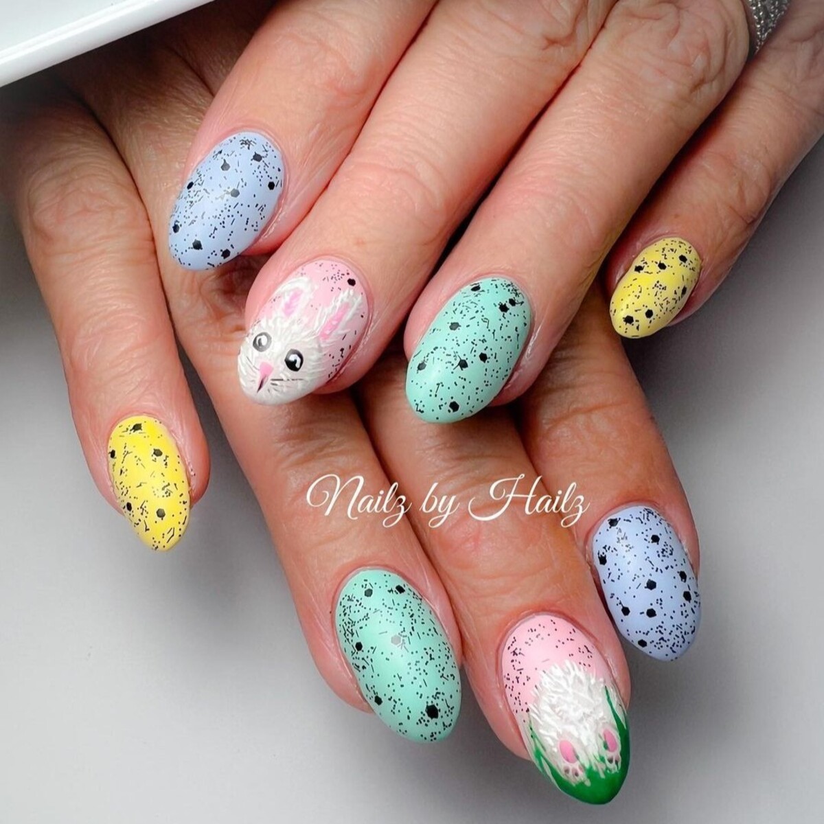 4. Speckled Pastel Nails with Bunny Portrait