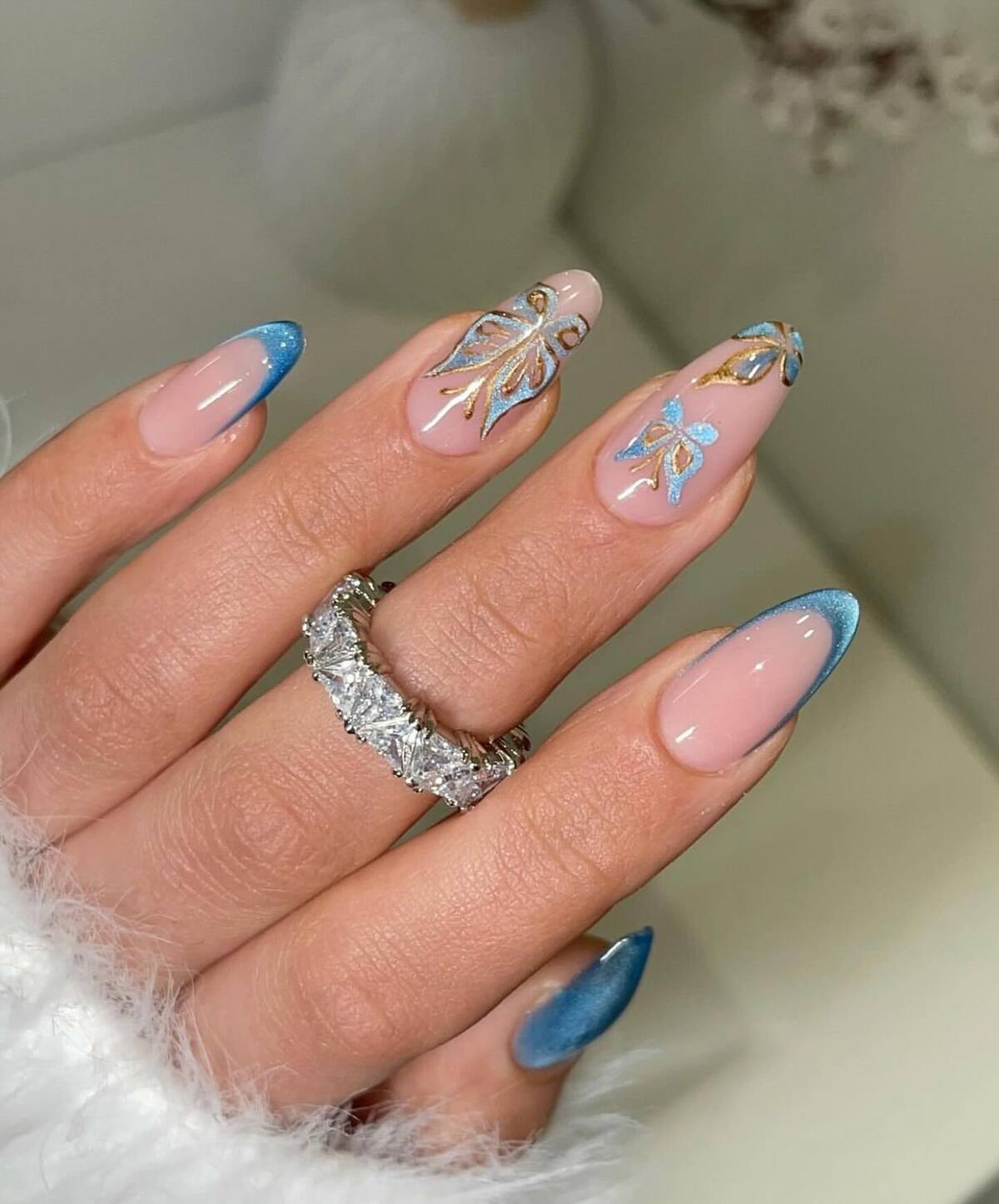 12. Butterfly-Inspired Blue French Tips