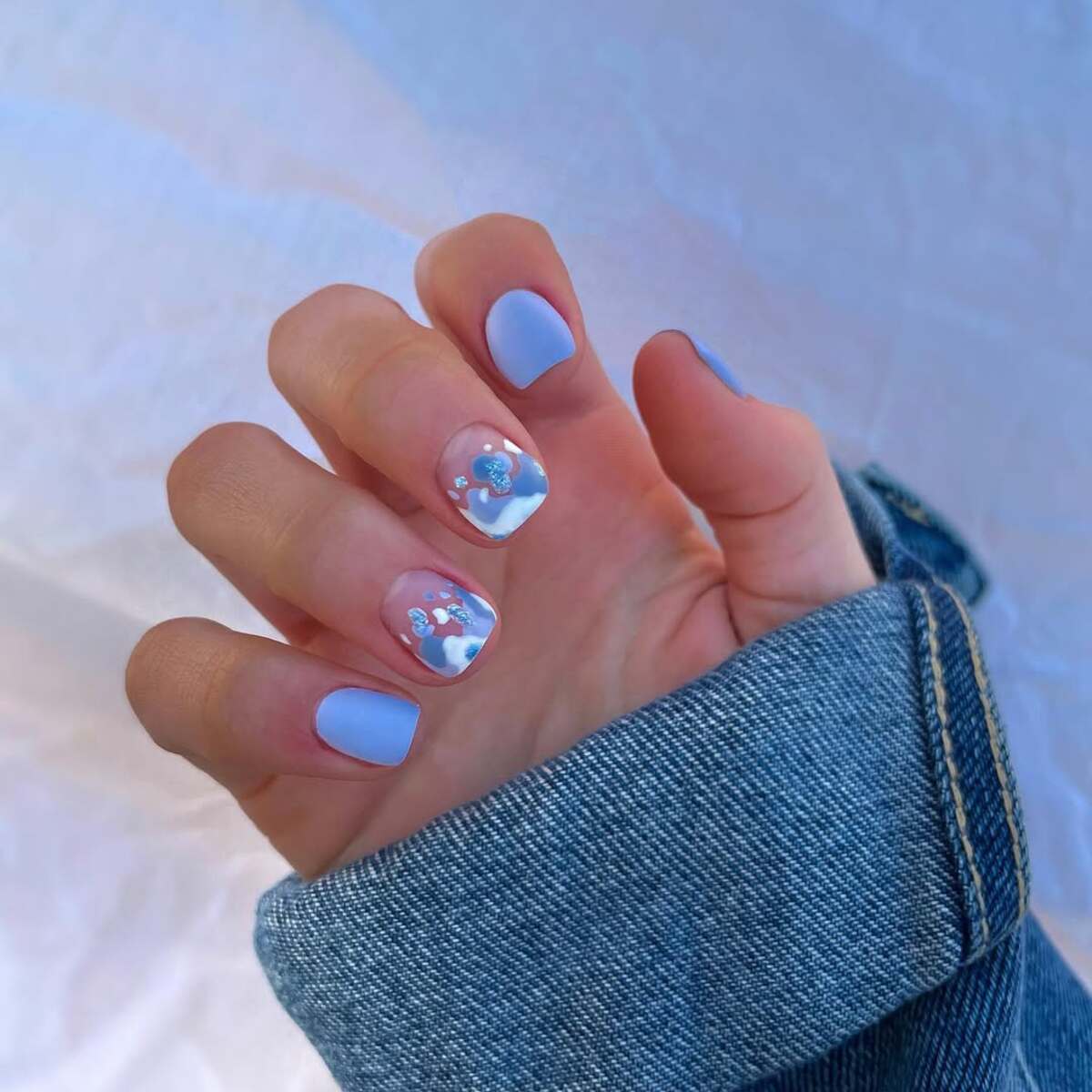 14. Soft Blue Short Nails with Delicate Art