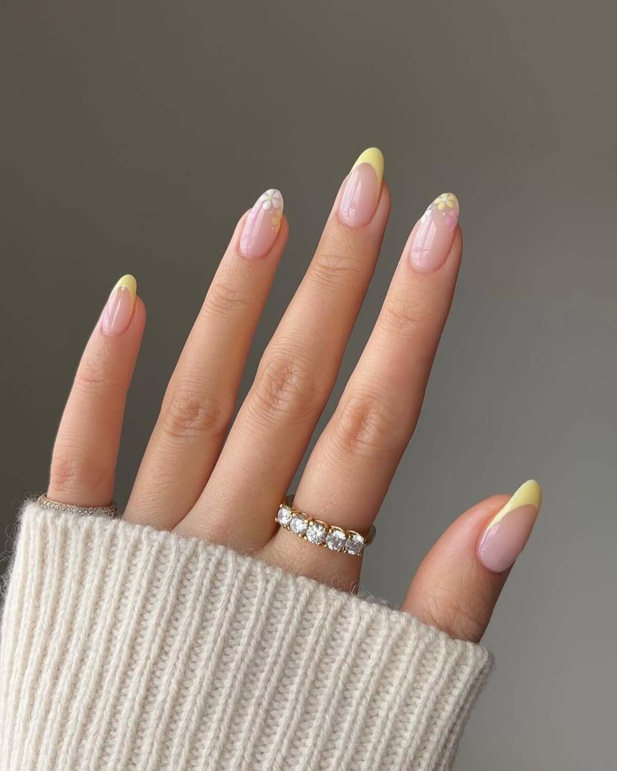 2. Soft Yellow French Tips with Subtle Floral Accents