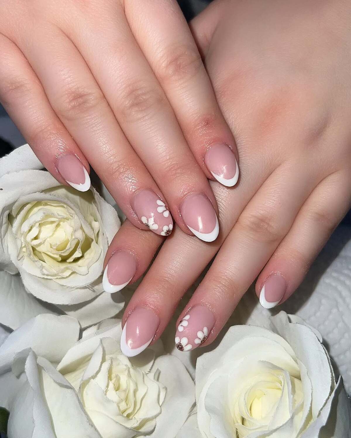 23. Classic French Tips with White Floral Accents