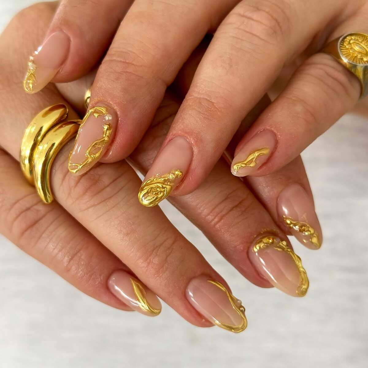 14. Subtle Nude Nails with Golden Fluid Accents